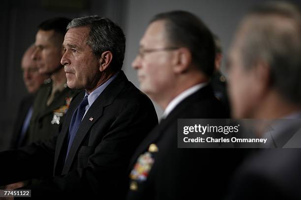 President George W. Bush is joined by US Vice President Dick Cheney and outgoing US Secretary of Defense Donald Rumsfeld during a meeting with the US...