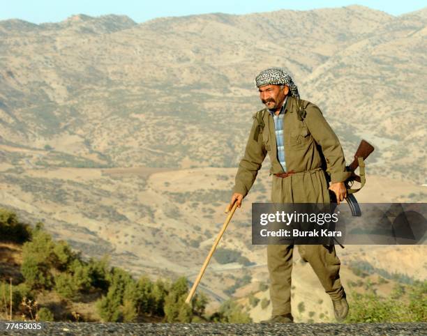 Pro-goverment village guard with an AK-47 patrols near Uludere on October 23, 2007 in the southeastern Turkish province of Sirnak at the Turkey-Iraq...