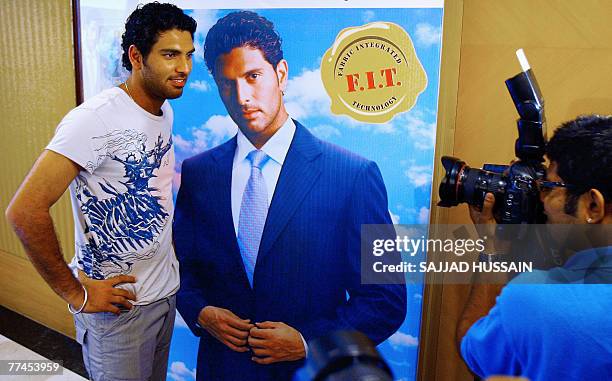 Indian cricketer Yuvraj Singh poses for photographers during a promotional event for brand endorsement in Mumbai, 23 October 2007. Indian cricketers,...