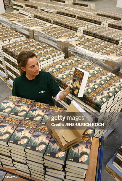 An Amazon employee packs the German version of the latest book of the Harry Potter series 'Harry Potter and the Deathly Hallows', authored by J. K....