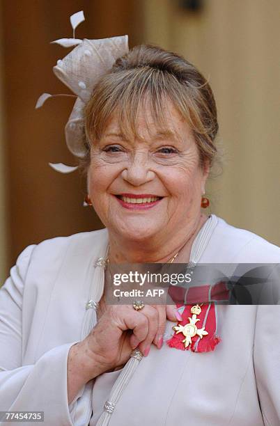 British actress Sylvia Syms is pictured after receiving her Member of the British Empire from Queen Elizabeth II at Buckingham Palace, in London, 18...