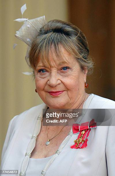 British actress Sylvia Syms is pictured after receiving her Member of the British Empire from Queen Elizabeth II at Buckingham Palace, in London, 18...