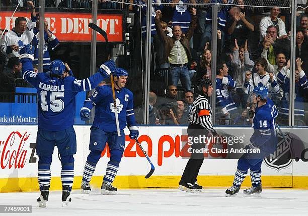 Mats Sundin of the Toronto Maple Leafs celebrates one of his goals with teammates Tomas Kaberle and Matt Stajan in a game against the Chicago...