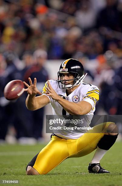 Daniel Sepulveda of the Pittsburgh Steelers receives the snap as he holds for place kicker Jeff Reed against the Denver Broncos at Invesco Field at...