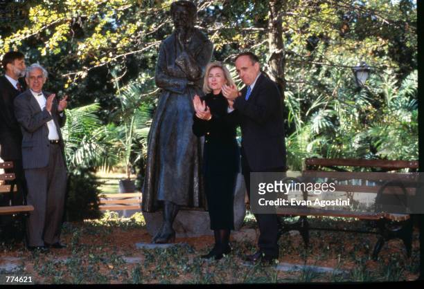 First Lady Hillary Clinton and New York City Mayor Rudy Giuliani clap at the unveiling of the Eleanor Roosevelt statue at Riverside Park October 5,...