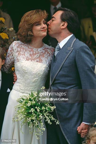 British composer and musical theatre impresario Andrew Lloyd Webber, kisses his wife, Madeleine Gurdon, outside Saint Botolph's Church following...