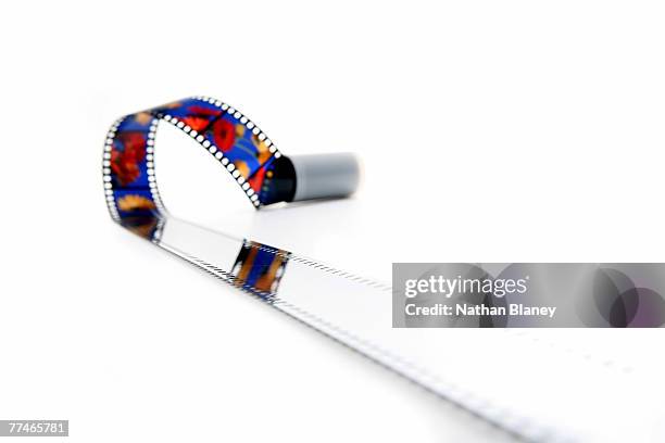 uncut slide film escaping from its plastic canister - film canister stock pictures, royalty-free photos & images