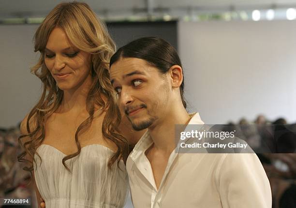 Artistic Director of Nina Ricci, Olivier Theyskens and a model walk the runway at the Couture Cares: A Benefit for Breast Cancer featuring an outdoor...