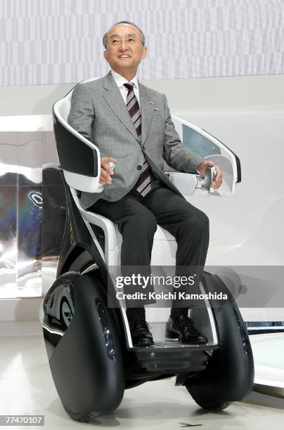 President of Toyota Motor Corp, Katsuaki Watanabe introduces the company's new vehicle, i-Real during the press day of the 40th Tokyo Motor Show at...