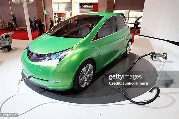 Fuji Heavy Industries Ltd's vehicle with the next generation Lithium-Ion battery is charged during the press day of the 40th Tokyo Motor Show at...