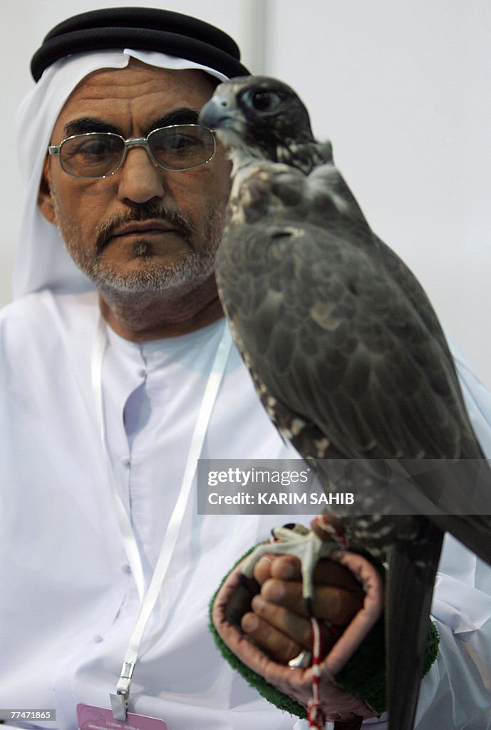 An Emirati man holds a falcon, 24 Octobe