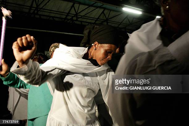 People from the Isaiah Shembe church sing and dance, 24 October 2007, during the memorial service for South African reggae musician Lucky Dube,...