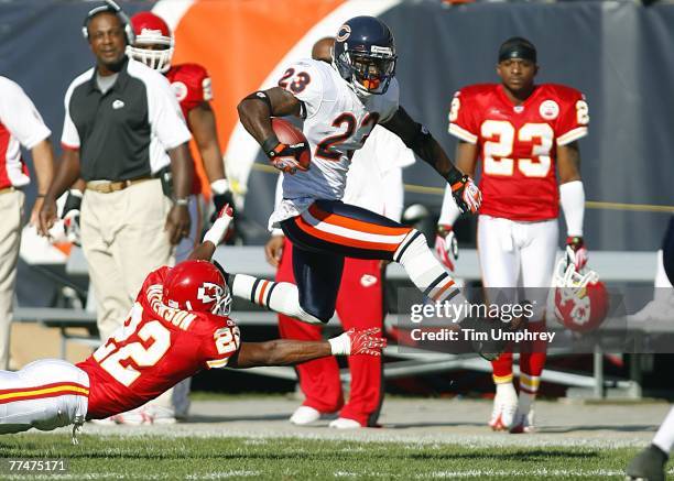 Wide receiver Devin Hester of the Chicago Bears hurdles to avoid being tackled by cornerback Dimitri Patterson of the Kansas City Chiefs in a game at...