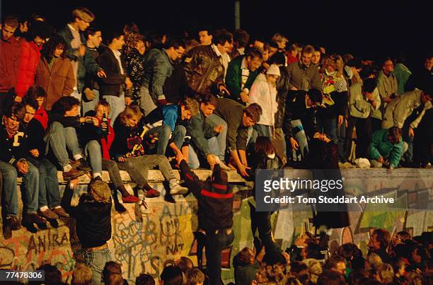 Crowds bear witness to the Fall of the Berlin Wall, November 1989. This is a section of the wall near the Brandenburg Gate – a high profile location...