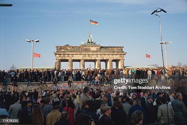 Crowds at the Brandenburg Gate bear witness to the Fall of the Berlin Wall, 10th November 1989.