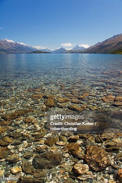 clear waters of lake wakatipu, near queenstown, otago, south island, new zealand, pacific - lake wakatipu stock pictures, royalty-free photos & images