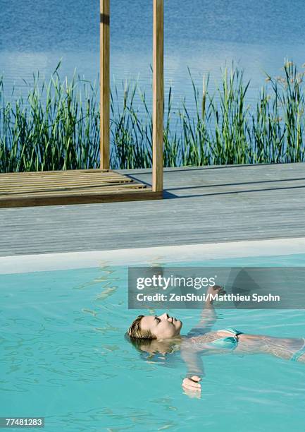 Woman Floating In Pool Young Woman Floating In Pool High-Res Stock Photo - Getty Images