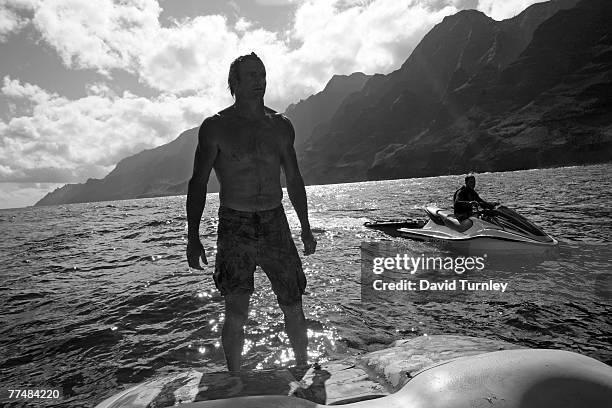 World famous big wave surfer Laird Hamilton looks for dolphins along the Nepali coastline in Hawaii.
