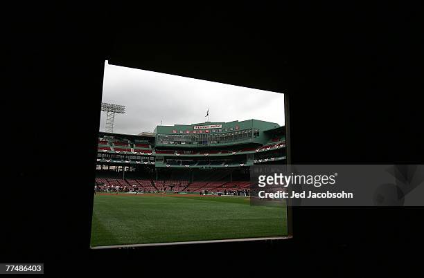 View from the scoreboard room behind the Green Monster of the field as members of the groundscrew make final preperations prior to Game One of the...