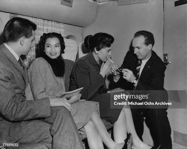 S: Passengers enjoy a relaxing smoke on a Transocean Air lines Boeing 377 Stratocruiser in the mid 1950's. Transocean Air lines flew between 1946 and...