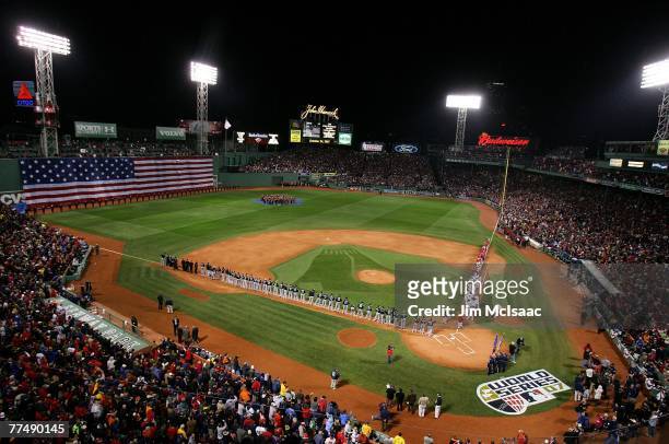 The Colorado Rockies and the Boston Red Sox stand at attention as the National Anthem is played before Game One of the 2007 Major League Baseball...
