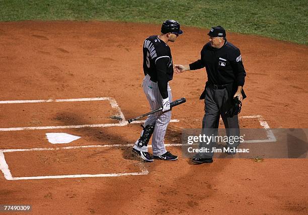 Matt Holliday of the Colorado Rockies argues a call with home plate umpire Ed Montague after striking out to end the first inning against the Boston...