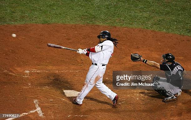 Manny Ramirez of the Boston Red Sox hits an RBI double in the fifth inning against the Colorado Rockies in the bottom of the fifth inning during Game...