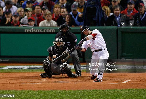 Dustin Pedroia of the Boston Red Sox hits a solo home run in the first inning against the Colorado Rockies during Game One of the 2007 Major League...