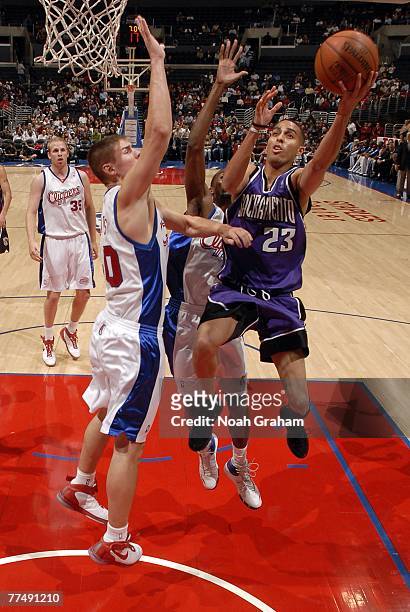 Kevin Martin of the Sacramento Kings goes up for a layup against Paul Davis of the Los Angeles Clippers at Staples Center on October 24, 2007 in Los...