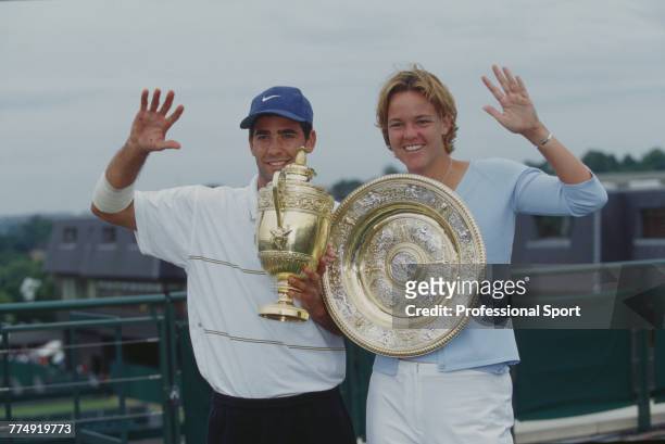 American tennis players Pete Sampras pictured left holding the Gentlemen's Singles Trophy and Lindsay Davenport, holding the Venus Rosewater Dish,...