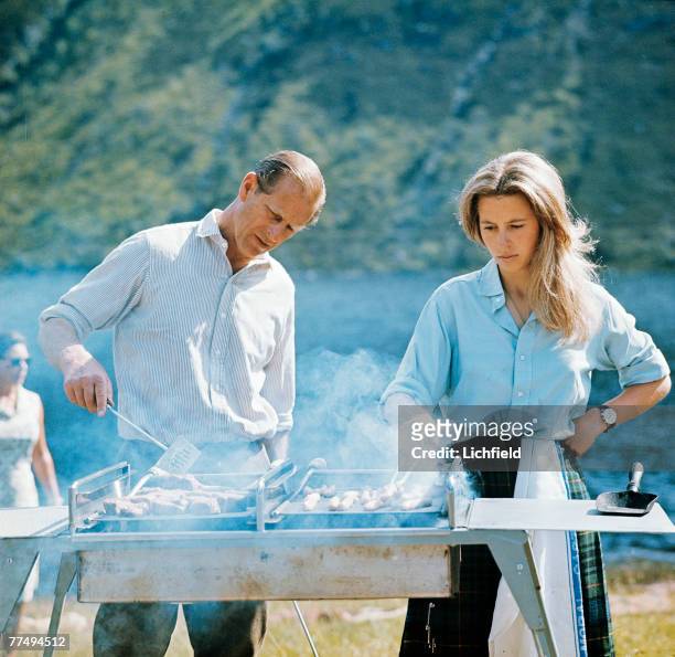 The Duke of Edinburgh and HRH The Princess Anne preparing a barbecue on the Estate at Balmoral Castle, Scotland during the Royal Family's annual...