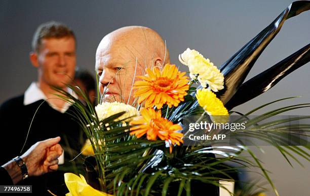 Swedish artist Torsten Andersson holds a bouquet of flowers after being awarded with the Carnegie Art Award 2008 during a ceremony, 25 October 2007...