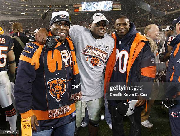 Thomas Jones, center, poses with his father and brother Julius Jones of the Dallas Cowboys after the Bears won the 2007 NFC Championship game between...