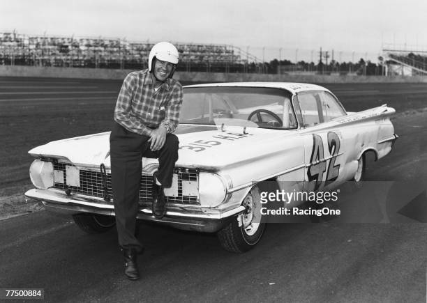Lee Petty driver of the Oldsmobile poses in front of his car before the first 1959 Winston Cup Daytona 500 race at the Daytona International Speedway...