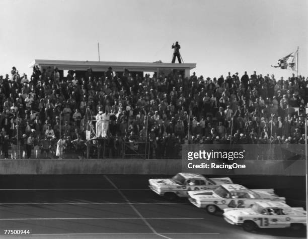 Lee Petty driver of the Oldsmobile races to the line against Johnny Beauchamp driver of the Holman Moody Ford during the first 1959 Winston Cup...