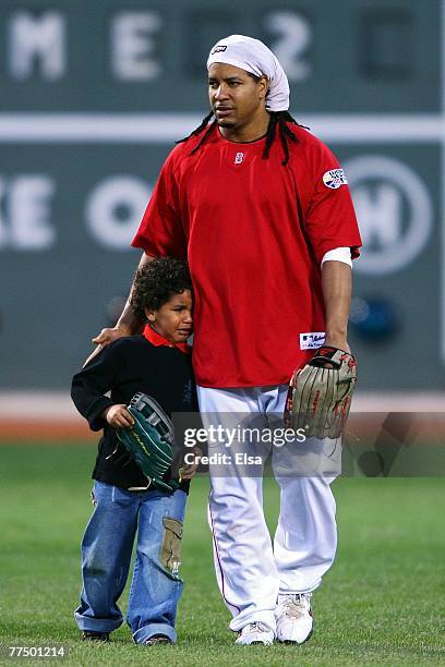 Manny Ramirez of the Boston Red Sox walks on the field with his son Manny as he cries during batting practice before Game Two of the 2007 Major...