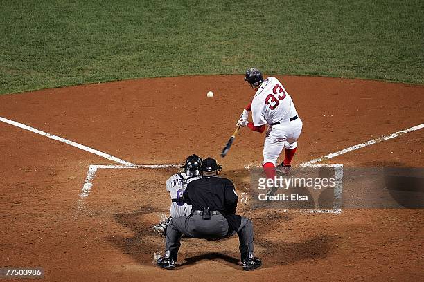 Jason Varitek of the Boston Red Sox connects for a sacrifice fly RBI against the Colorado Rockies during Game Two of the 2007 Major League Baseball...
