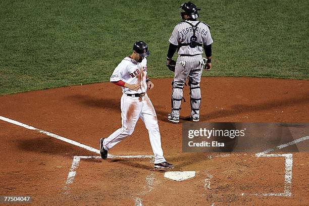 Mike Lowell of the Boston Red Sox scores on a sacrifice fly by Jason Varitek against the Colorado Rockies during Game Two of the 2007 Major League...