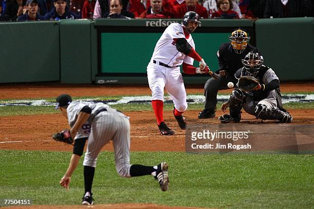 Jason Varitek of the Boston Red Sox connects for a sacrifice fly against the Colorado Rockies during Game Two of the 2007 Major League Baseball World...