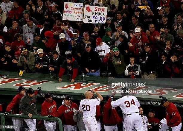 David Ortiz of the Boston Red Sox is congratualted by Kevin Youkilis after scoring against the Colorado Rockies during Game Two of the 2007 Major...