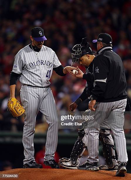 Jeremy Affeldt of the Colorado Rockies hands over the ball to Manager Clint Hurdle as catcher Yorvit Torrealba looks on during Game Two of the 2007...