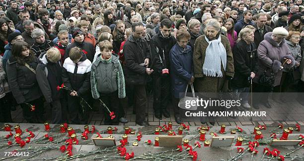 Crowd of people lay flowers during a commemoration ceremony at the Dubrovka Theatre in Moscow, 26 October 2007, for the 5th anniversary of the...