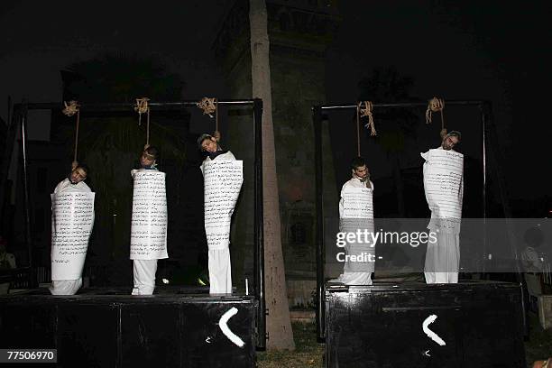 Five executed Syrian men hang from the gallows with signs detailing their crimes wrapped around their bodies in the centre of the northern town of...