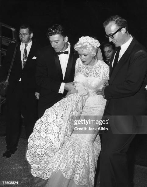 American actress Jayne Mansfield and her second husband Mickey Hargitay make their way to the dressing room after their wedding at Palos Verdes, 13th...