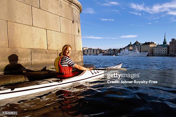 woman canoeing in stockholm sweden. - stockholm summer stock-fotos und bilder