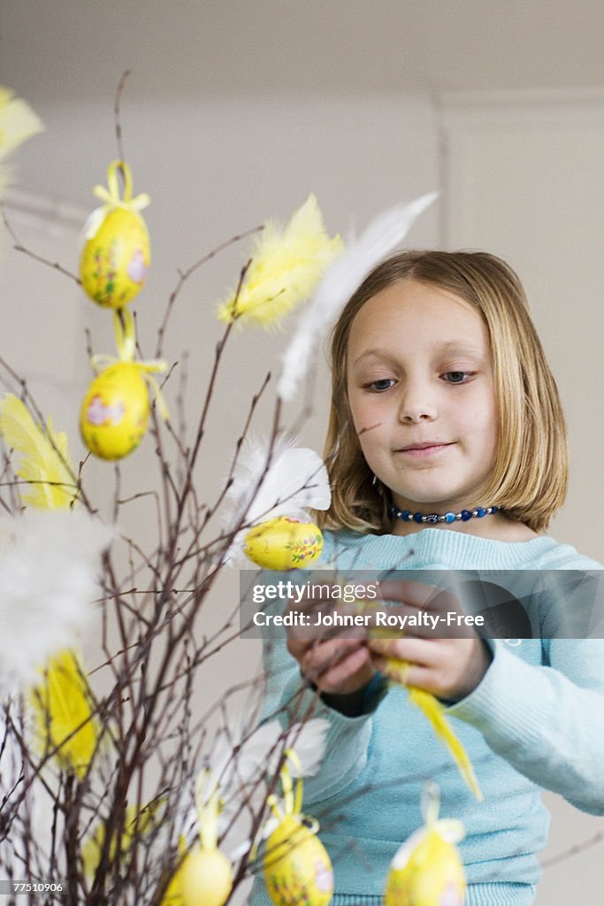 A girl making Easter decorations.