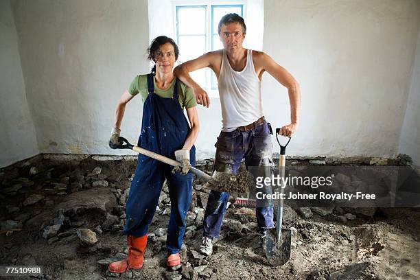 scandinavian couple renovating the floor in a room oland sweden. - sledgehammer stock-fotos und bilder