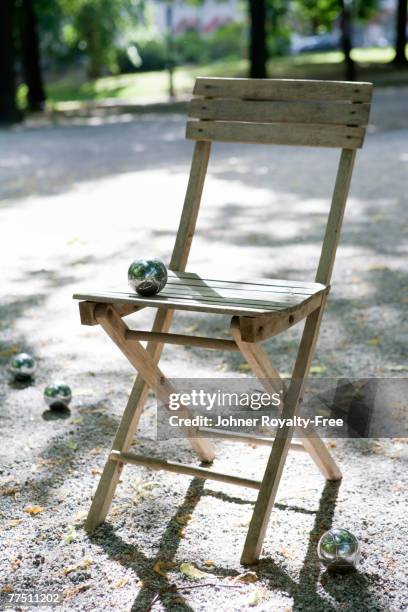 folding chair outdoors with bocce balls - bocce stock pictures, royalty-free photos & images