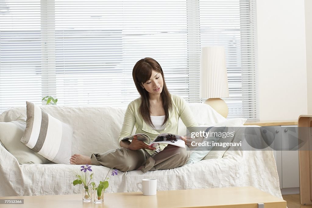 Woman on Sofa Reading a Magazine