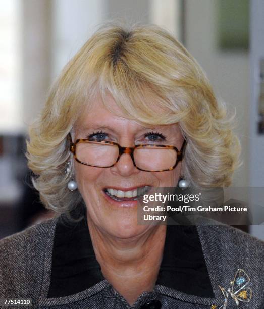 Camilla, Duchess of Cornwall wears glasses to try calligraphy during a visit to the Pound Centre, an arts centre which the Duchess officially opened...